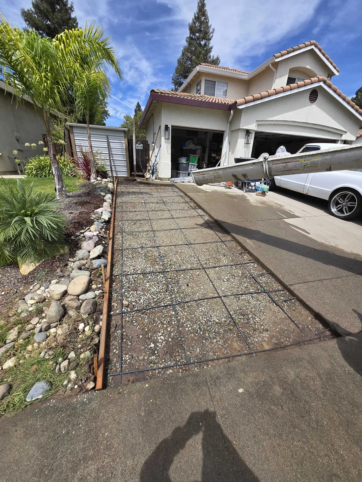 Driveway forms set with a tied rebar grid, ready for the concrete pour